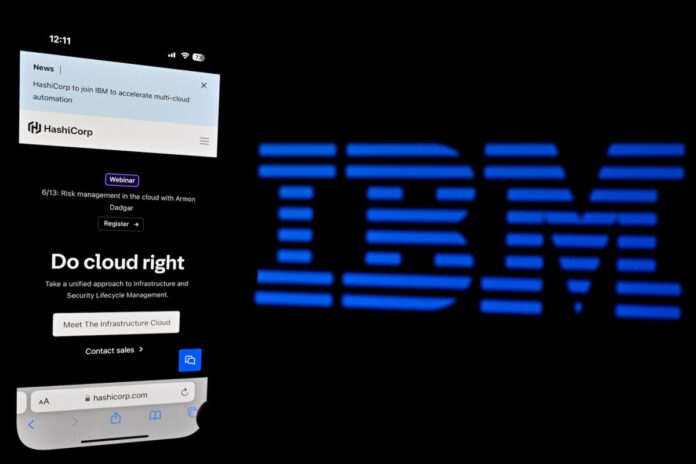 In this photo illustration, a logo of HashiCorp is displayed on a mobile phone screen with IBM logo visible.