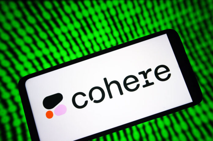 Image of a phone with Cohere's logo on it with a green digital background.
