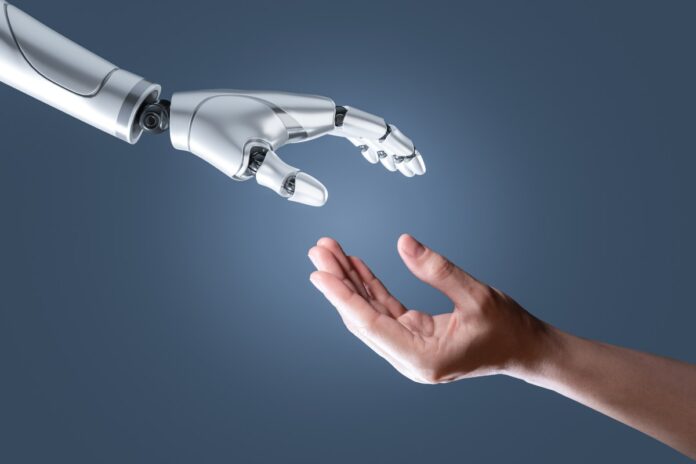 Humanoids.jpg image of a humanoid hand reaching out to a human hand