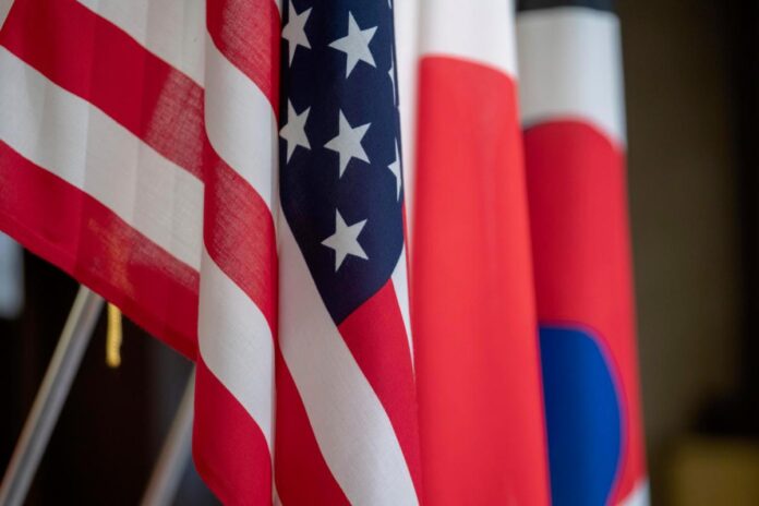 Flags representing the United States, Japan and the Republic of Korea